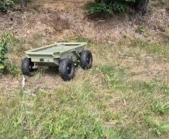TALOS UGV driving through scrub and grass under remote control